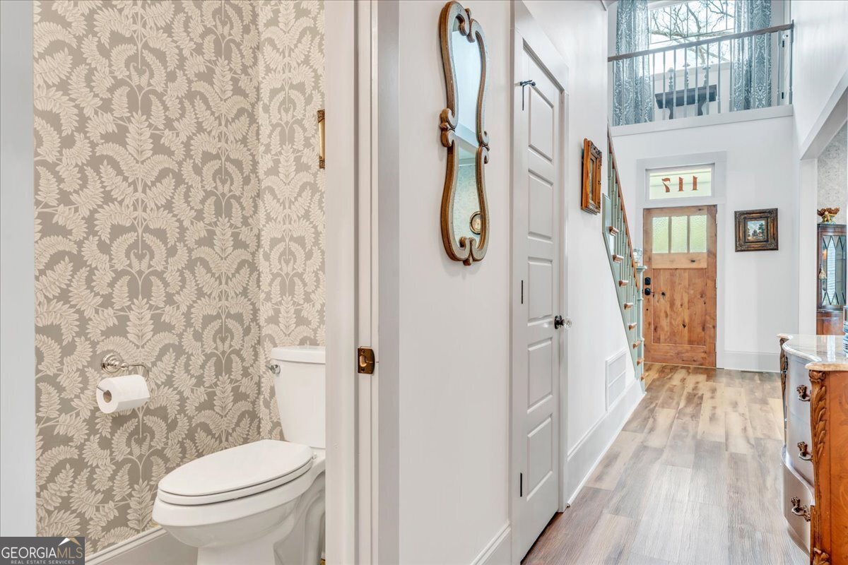 117 Pine Bough Trail Perry, GA 31069 - Photo 20 of 83 a bathroom with a toilet and a shower curtain