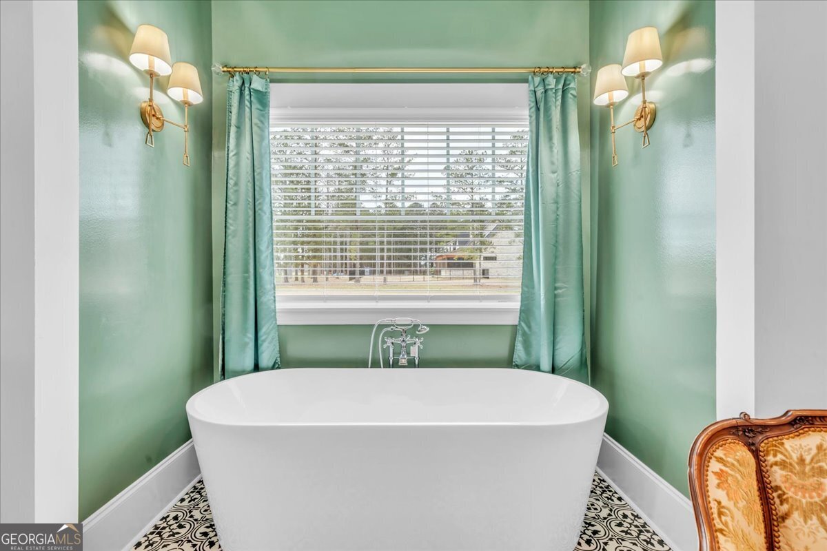 117 Pine Bough Trail Perry, GA 31069 - Photo 29 of 83 a white bath tub sitting in a bathroom next to a window