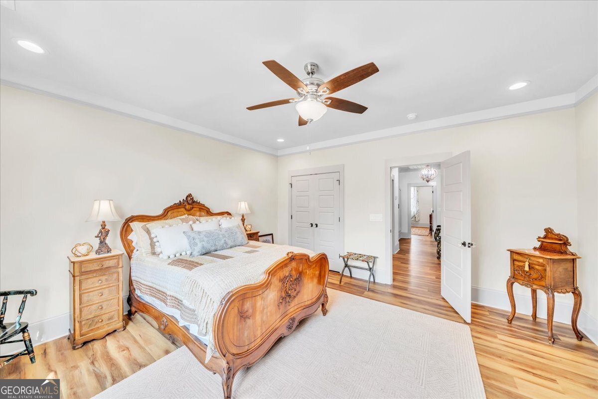 117 Pine Bough Trail Perry, GA 31069 - Photo 41 of 83 a bedroom with a bed and a chandelier