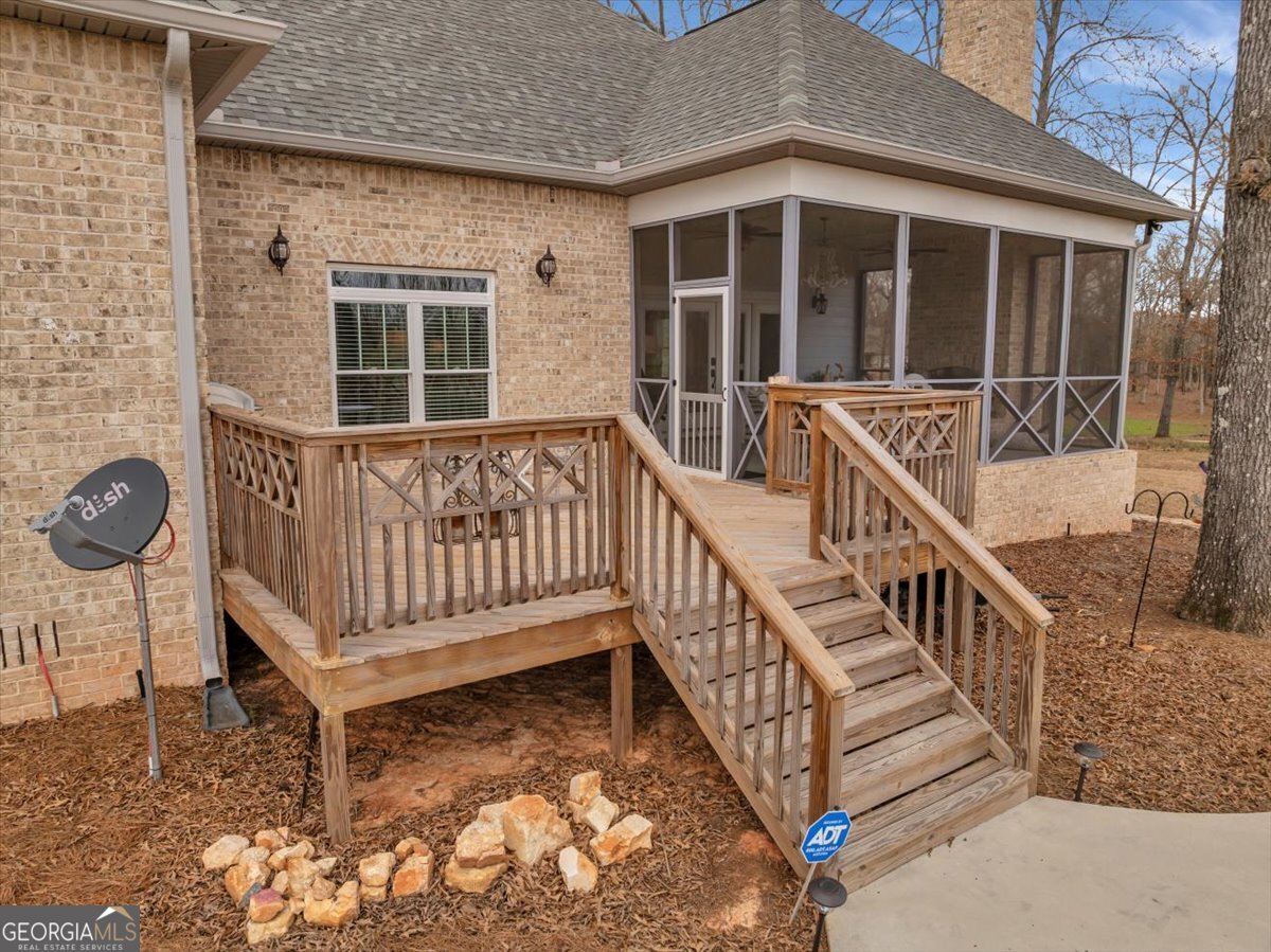 117 Pine Bough Trail Perry, GA 31069 - Photo 52 of 83 a view of a house with wooden deck and a yard