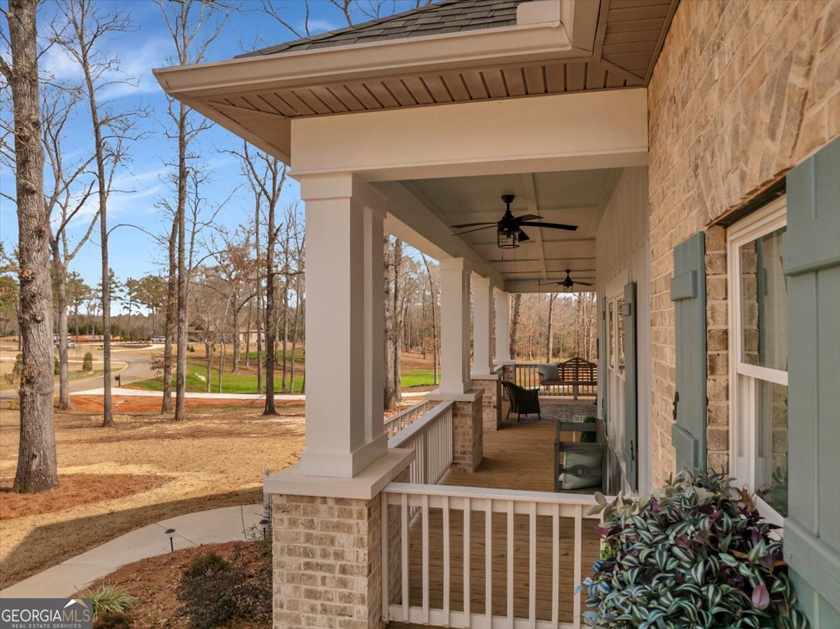 117 Pine Bough Trail Perry, GA 31069 - Photo 58 of 83 a view of a porch with furniture and floor to ceiling window