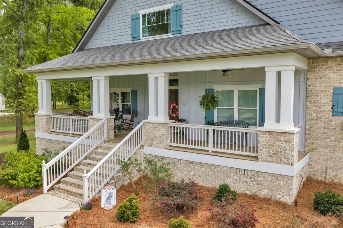 117 Pine Bough Trail Perry, GA 31069 - Photo 63 of 83 a view of a house with a wooden deck and a floor to ceiling window