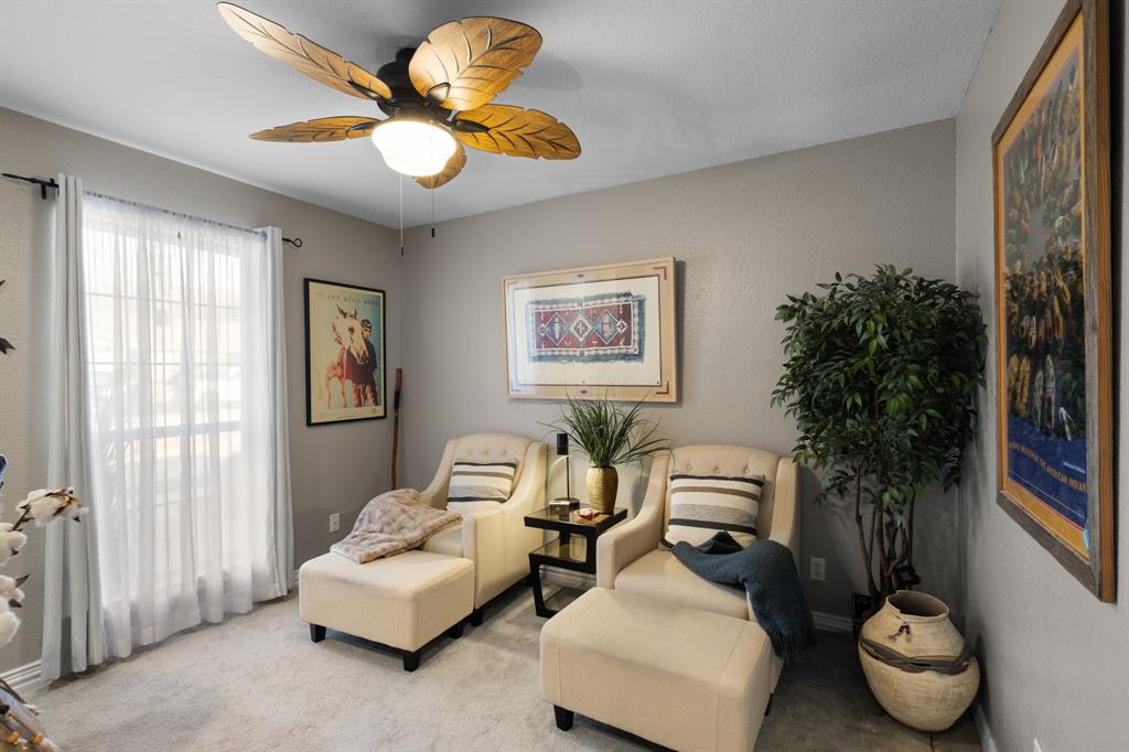 1701 Oakmeadow Drive Decatur, TX 76234 - Photo 21 of 39 a living room with furniture and a potted plant