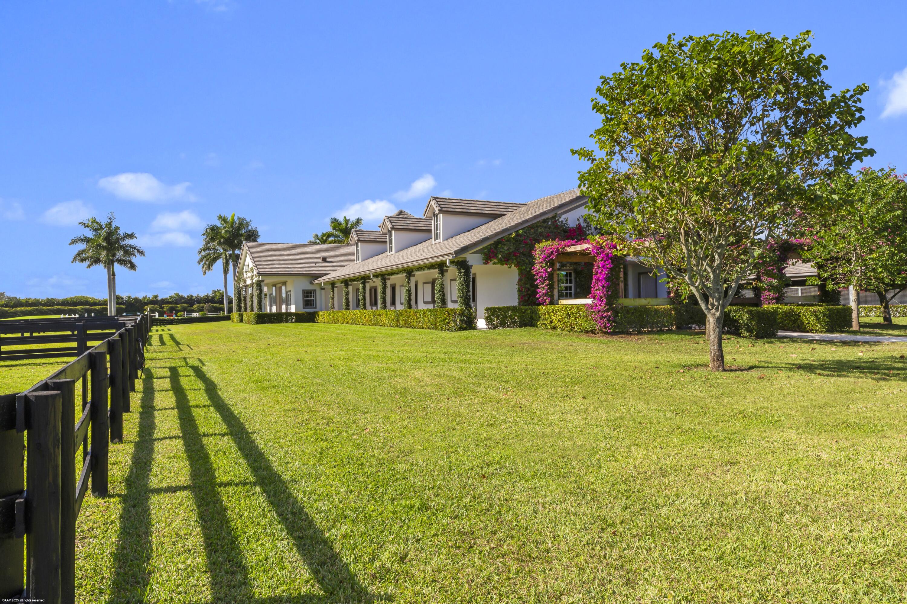 15527 Imperial Point Lane Wellington, FL 33414 - Photo 115 of 184 a front view of house with an outdoor space and seating