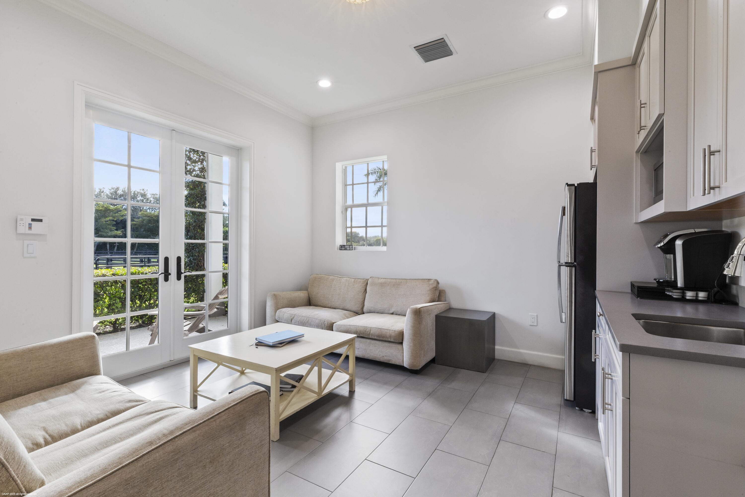 15527 Imperial Point Lane Wellington, FL 33414 - Photo 133 of 184 a living room with furniture and a fireplace