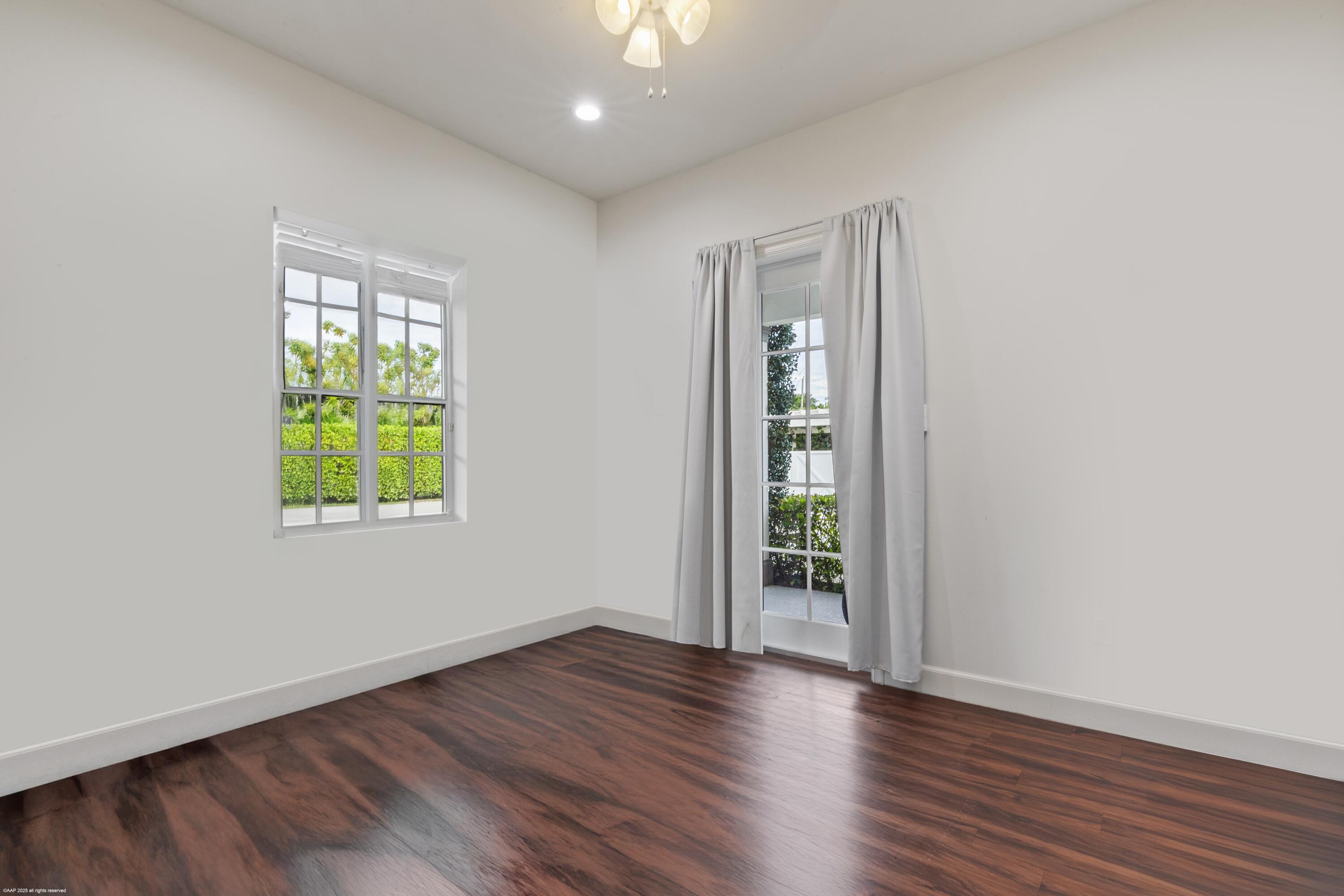 15527 Imperial Point Lane Wellington, FL 33414 - Photo 150 of 184 an empty room with wooden floor and windows