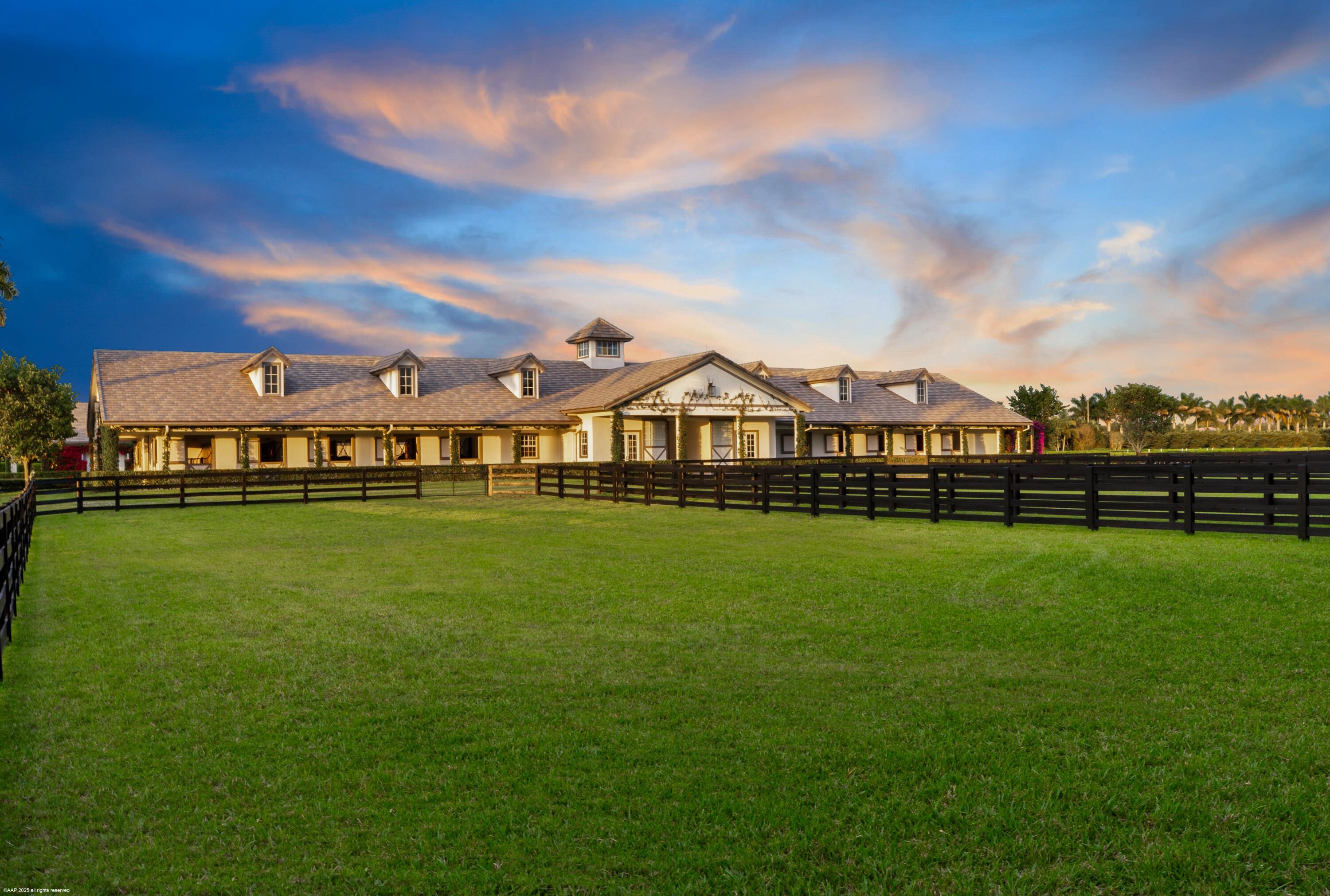15527 Imperial Point Lane Wellington, FL 33414 - Photo 173 of 184 a view of a big house with a big yard and large trees