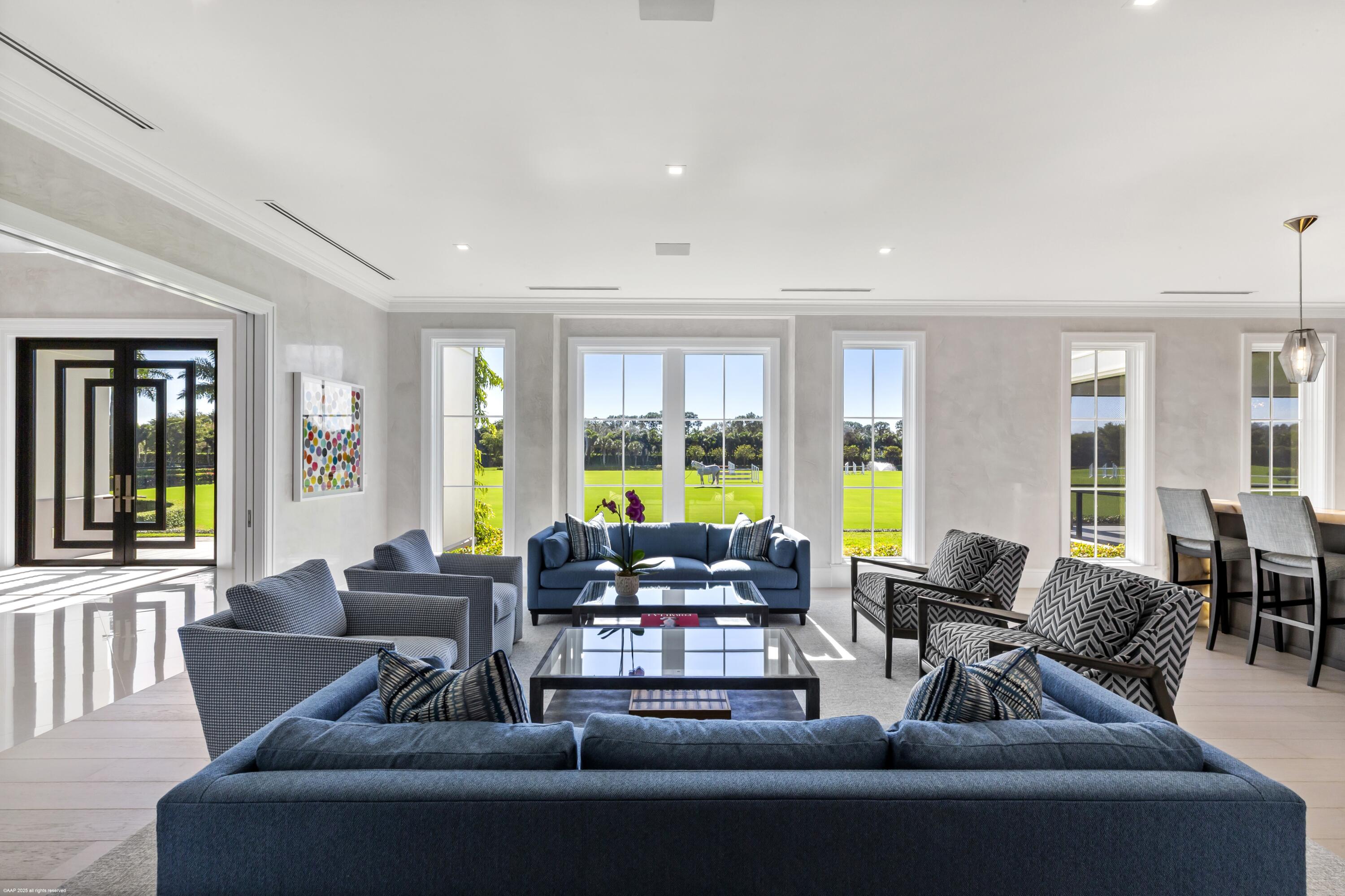 15527 Imperial Point Lane Wellington, FL 33414 - Photo 32 of 184 a living room with furniture and floor to ceiling windows