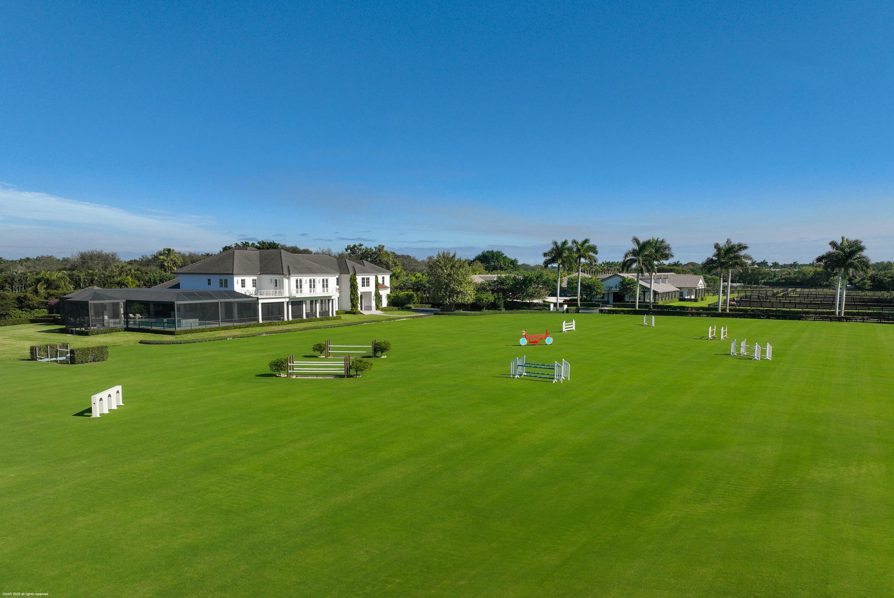 15527 Imperial Point Lane Wellington, FL 33414 - Photo 6 of 184 a view of building with garden and trees in the background