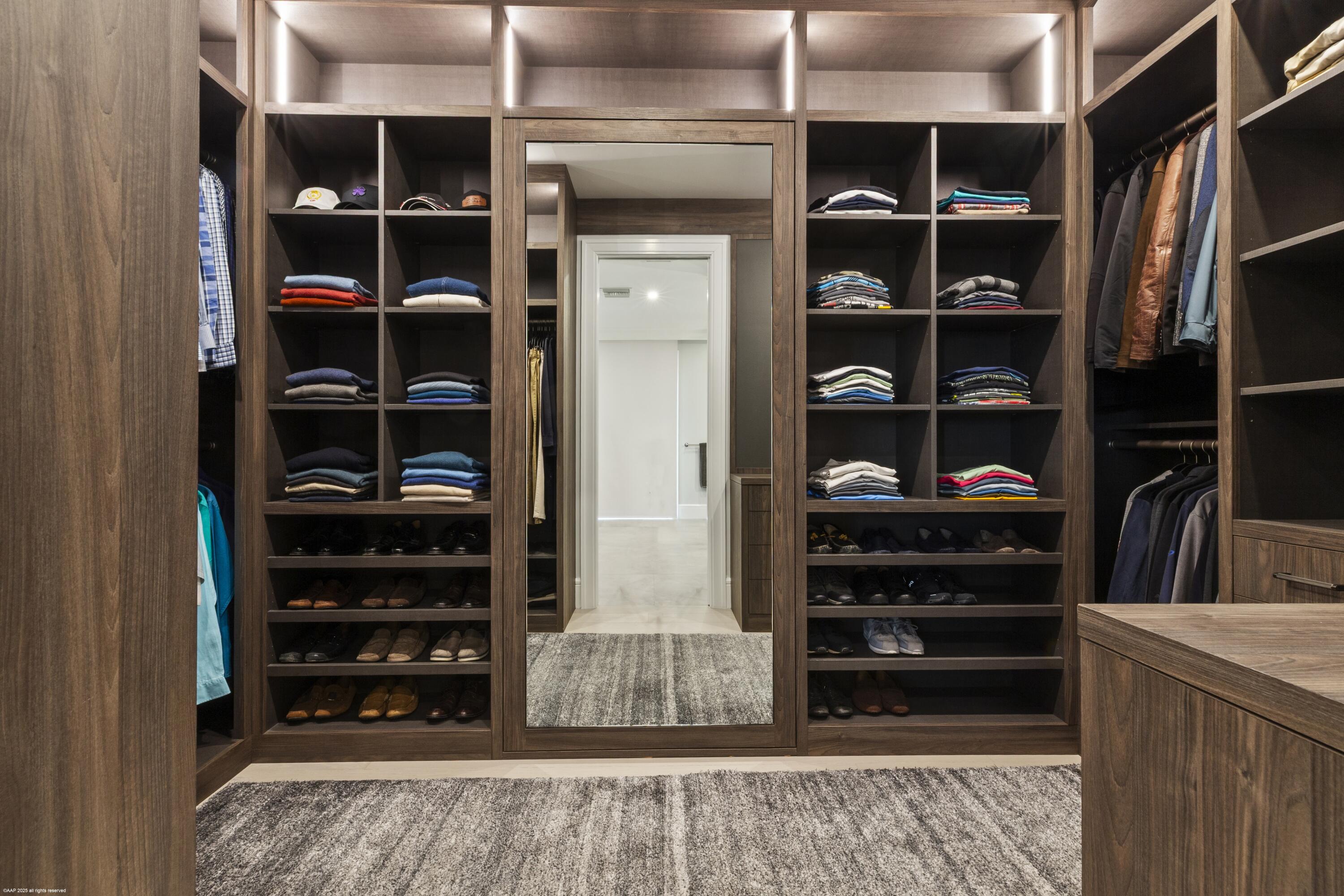 15527 Imperial Point Lane Wellington, FL 33414 - Photo 61 of 184 a view of walk in closet with clothes and shoes