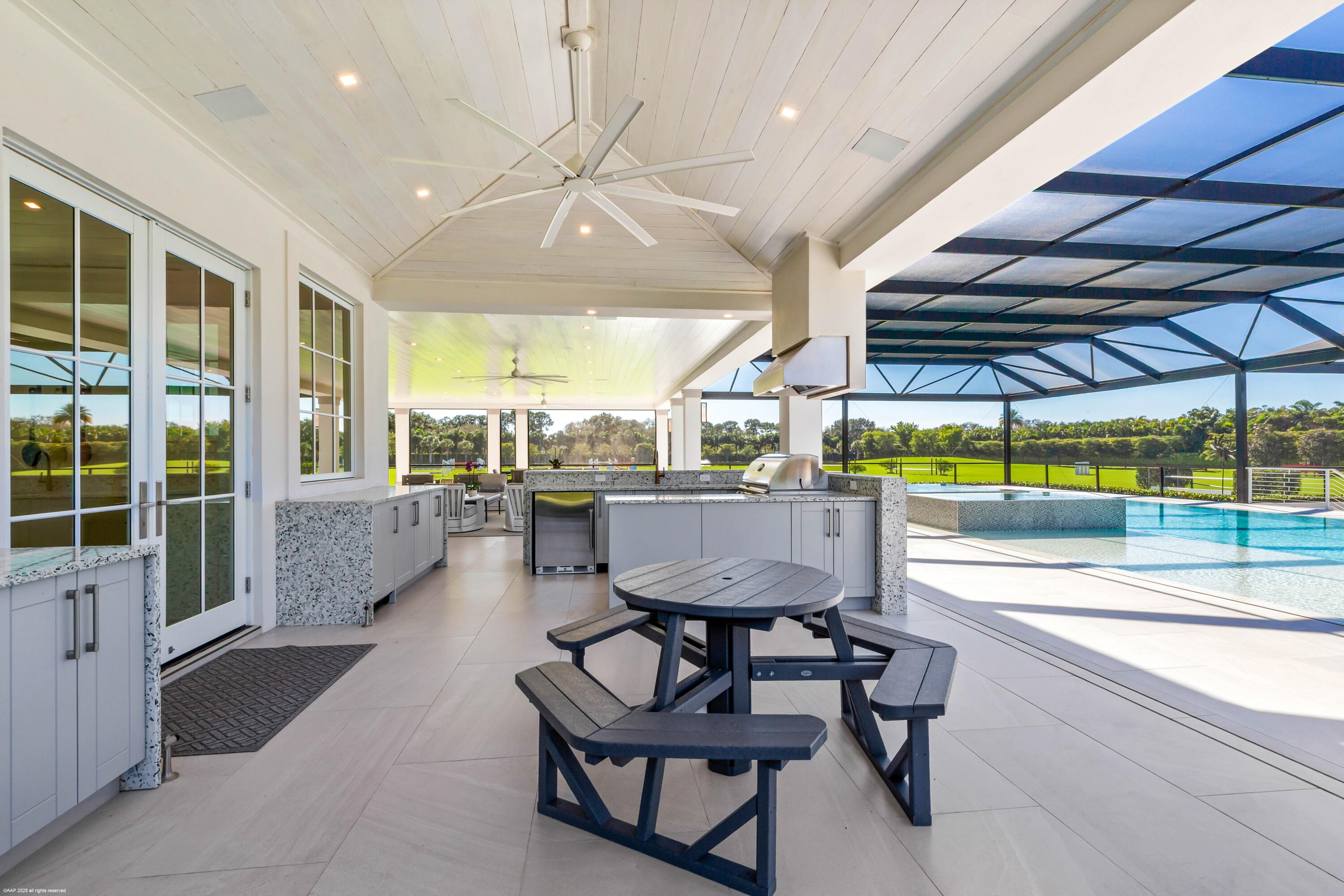 15527 Imperial Point Lane Wellington, FL 33414 - Photo 85 of 184 a view of a swimming pool with a table and chairs