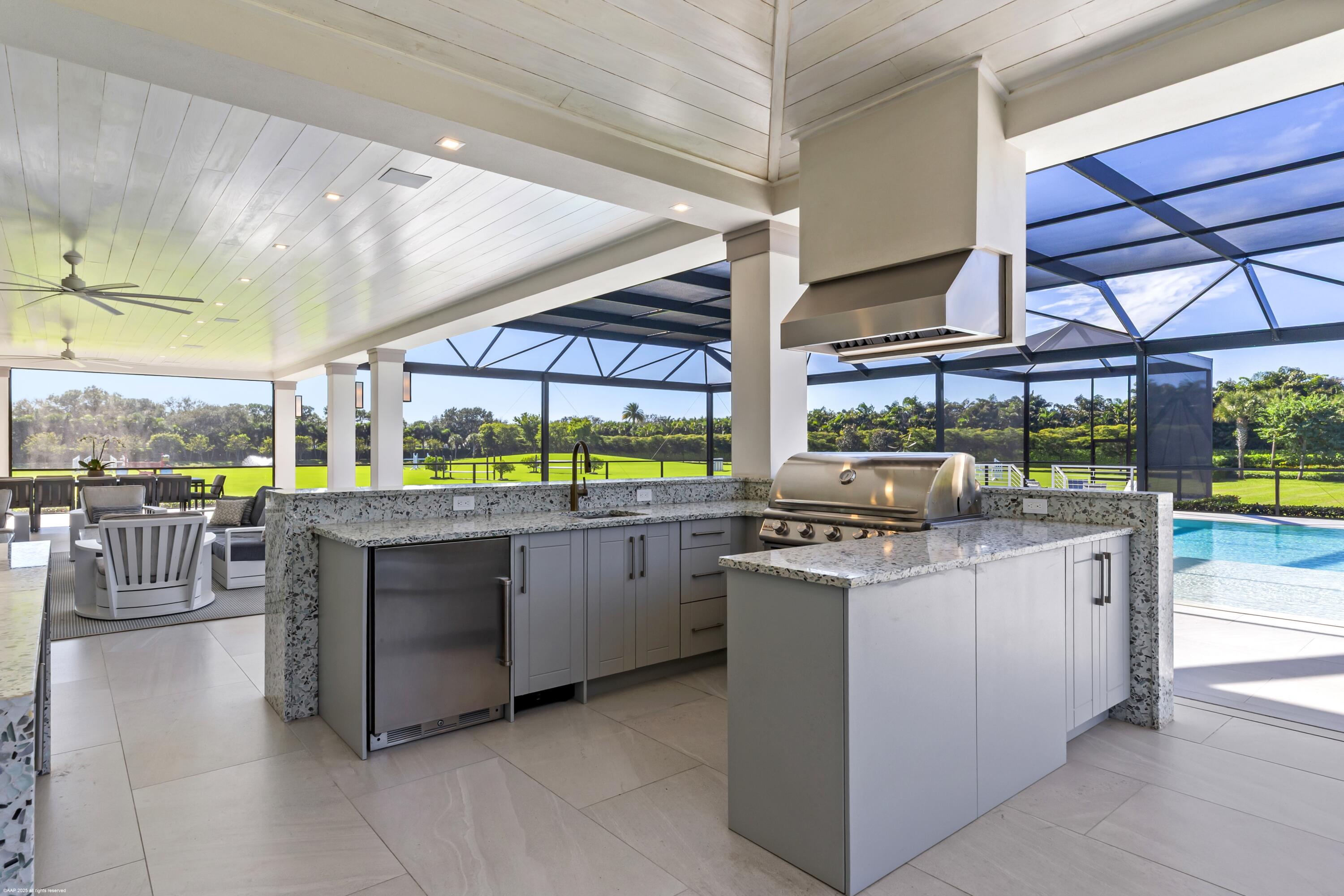 15527 Imperial Point Lane Wellington, FL 33414 - Photo 86 of 184 a kitchen with stainless steel appliances granite countertop a stove and a wooden cabinets