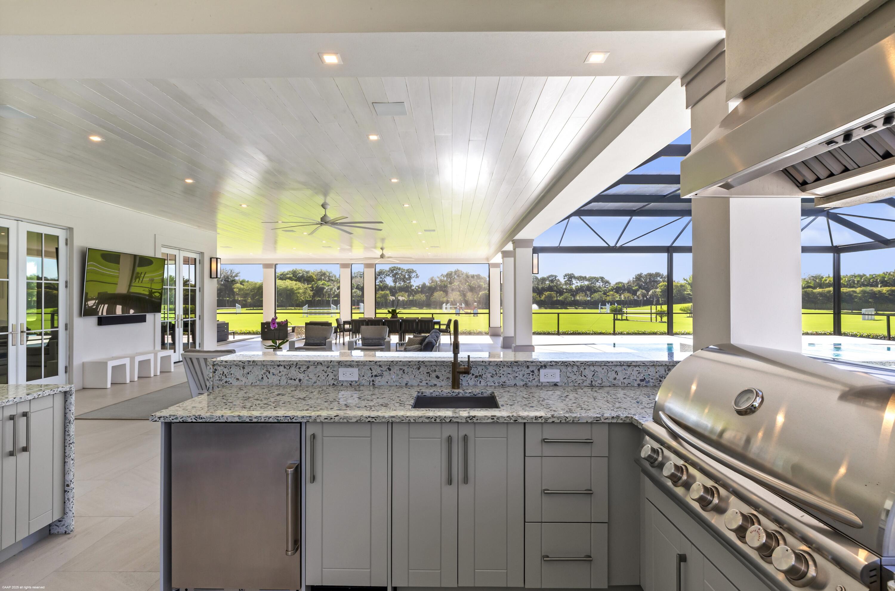 15527 Imperial Point Lane Wellington, FL 33414 - Photo 89 of 184 a kitchen with stainless steel appliances granite countertop a sink and a large window