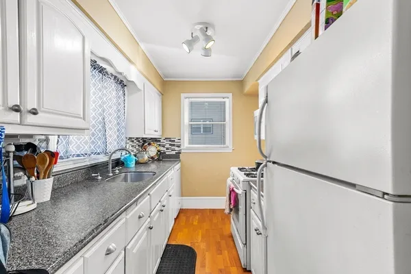 a kitchen with a sink a window and appliances