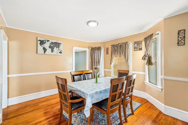 a view of a dining room with furniture and wooden floor