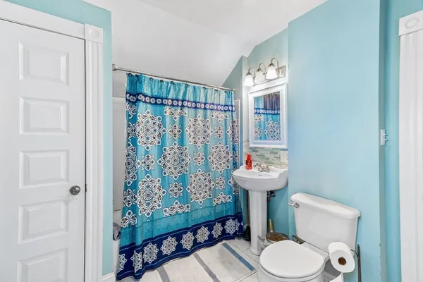 a bathroom with a sink toilet and a shower