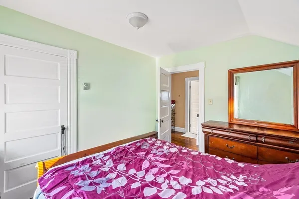 a bedroom with a bed and a dresser