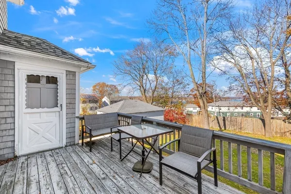 a backyard of a house with table and chairs