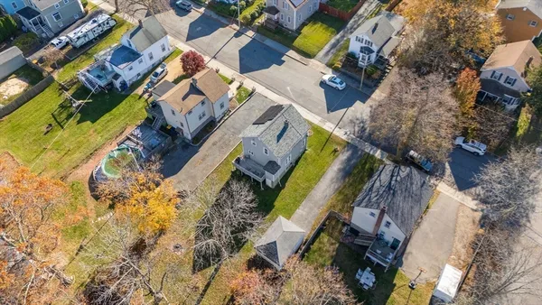 an aerial view of a house with a yard