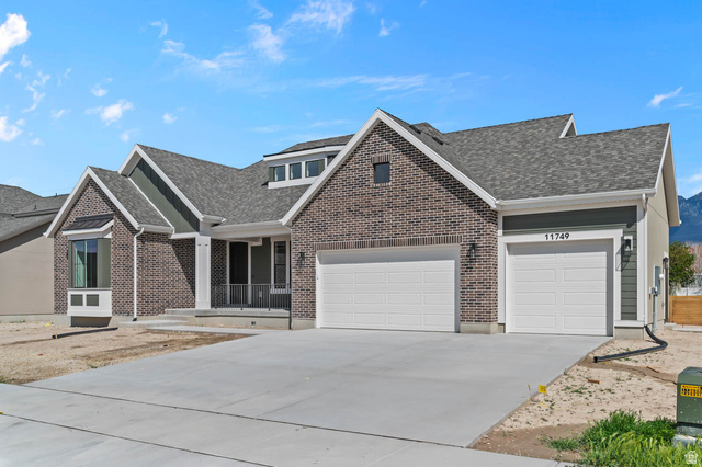 11749 South Halls Crk Road Draper, UT 84020 - Photo 3 of 21 View of front of property featuring concrete driveway, an attached garage, roof with shingles, a porch, and brick siding