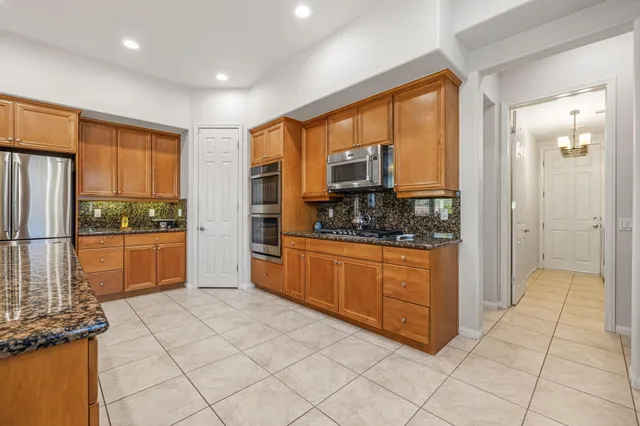 a bathroom with a granite countertop bathtub and a shower