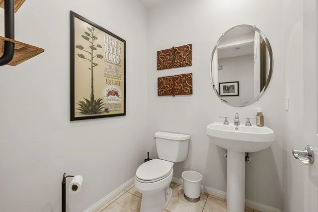 a view of a backyard with table and chairs and potted plants and large trees