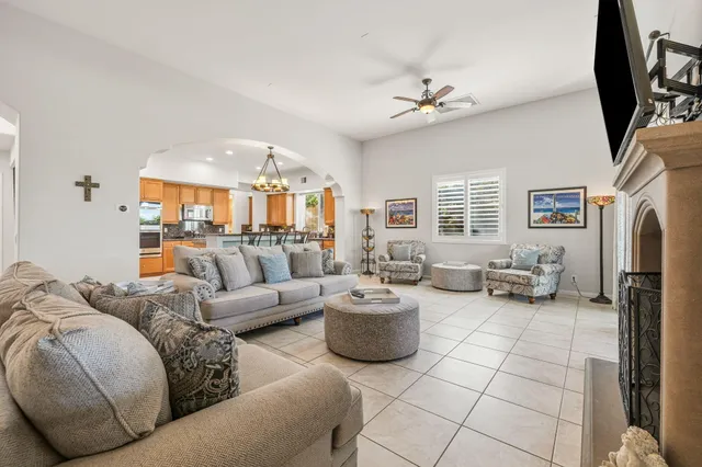 a living room with furniture a flat screen tv and a fireplace