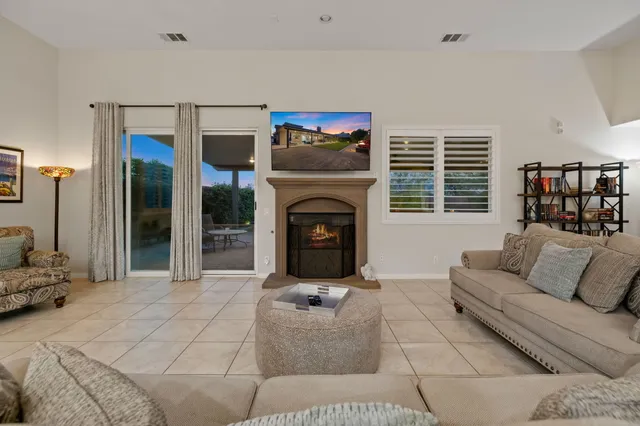 a kitchen with stainless steel appliances granite countertop a stove a refrigerator a oven a dining table and chairs with wooden floor