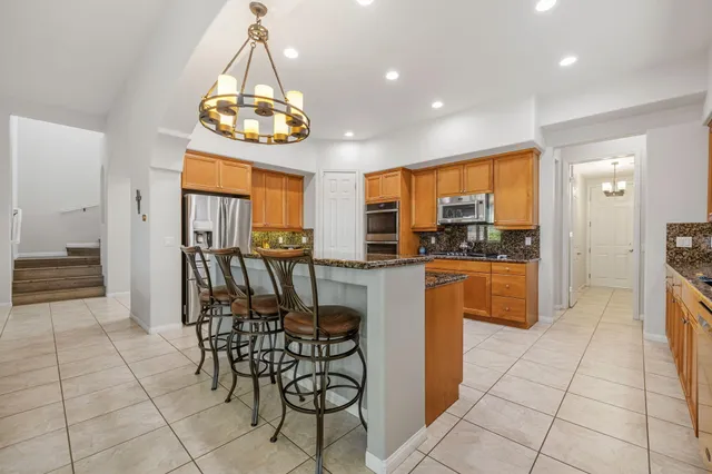 a view of a dining room with furniture and chandelier