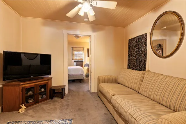 a bedroom with a bed and a flat tv screen on the dresser
