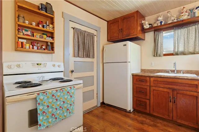 a backyard of house with a barbeque and wooden fence