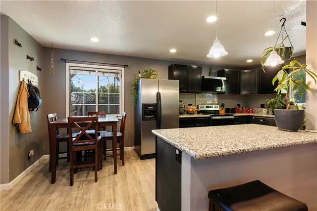 a kitchen with stainless steel appliances granite countertop a sink stove and cabinets