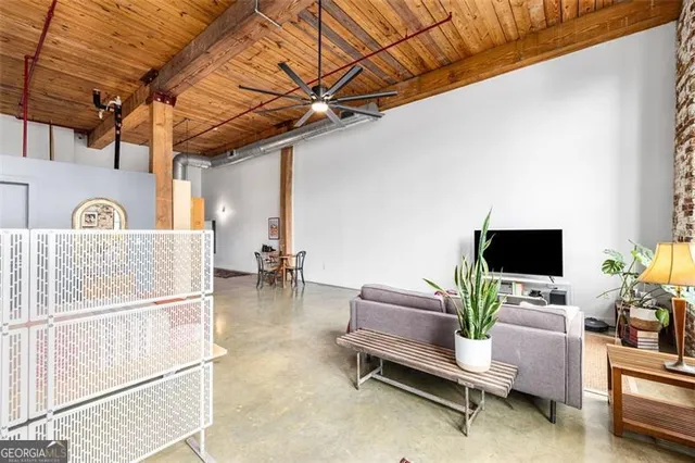 a spacious bedroom with a bed and a couch