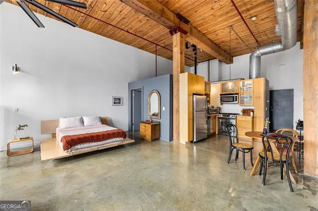 a living room with furniture a rug and a window