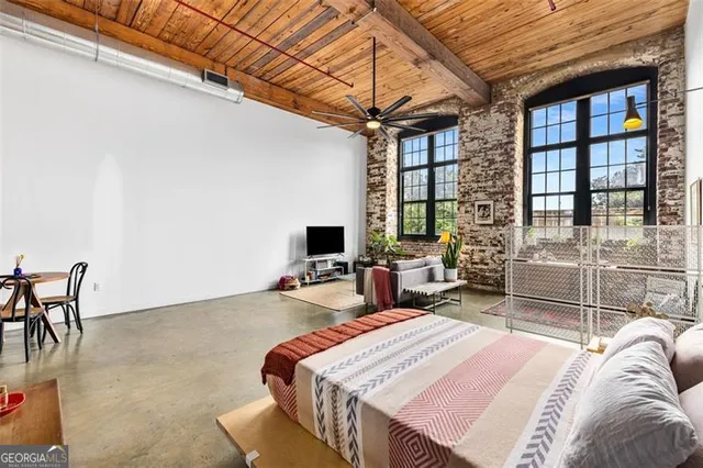 a bedroom with a bed and with furniture