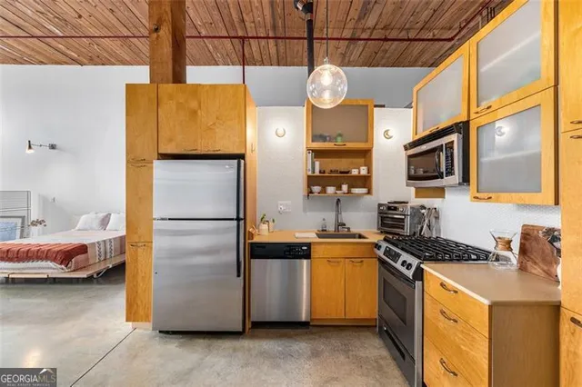 a kitchen with stainless steel appliances a refrigerator and a stove