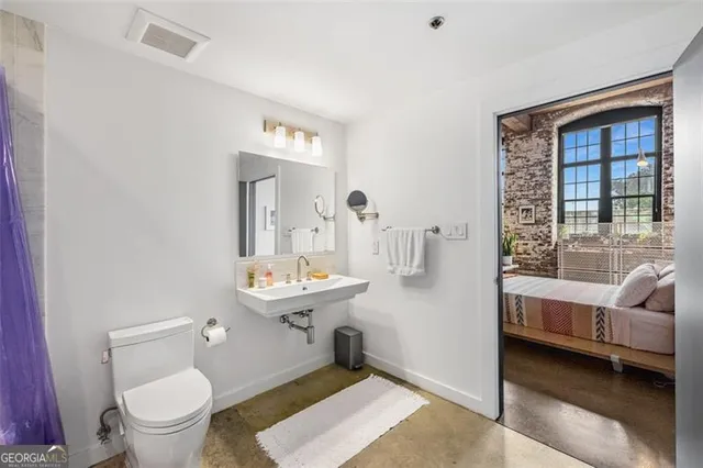 a view of walk in closet with clothes