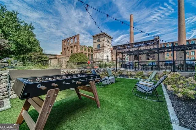 a view of a patio with a table and chairs and potted plants