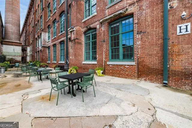 a view of a brick building next to a yard