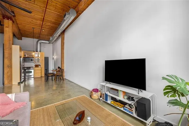 a living room with furniture and a flat screen tv