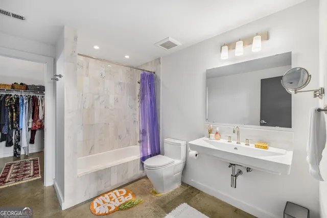 a bathroom with a sink toilet and shower