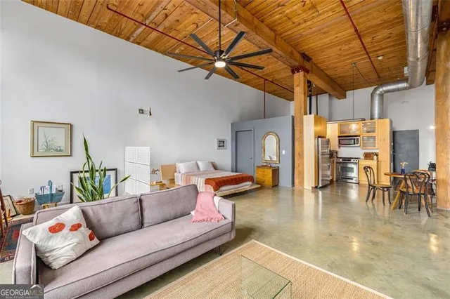 a view of a dining room with furniture and a window