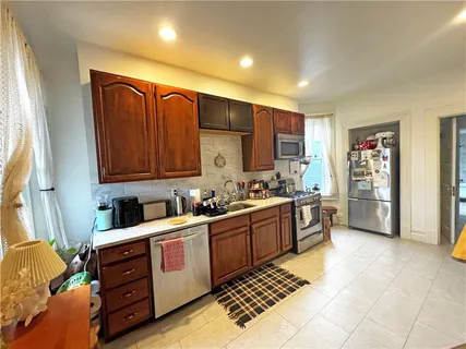 a kitchen with stainless steel appliances a stove sink and cabinets