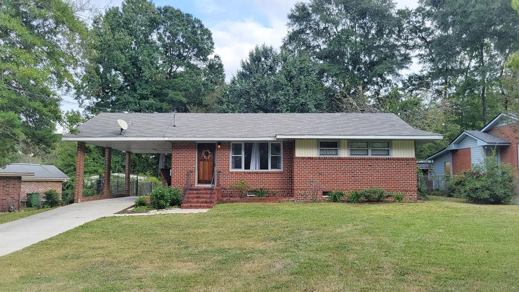 5552 Perry Avenue Columbus, GA 31909 - Photo 1 of 14 a front view of a house with a yard and garage