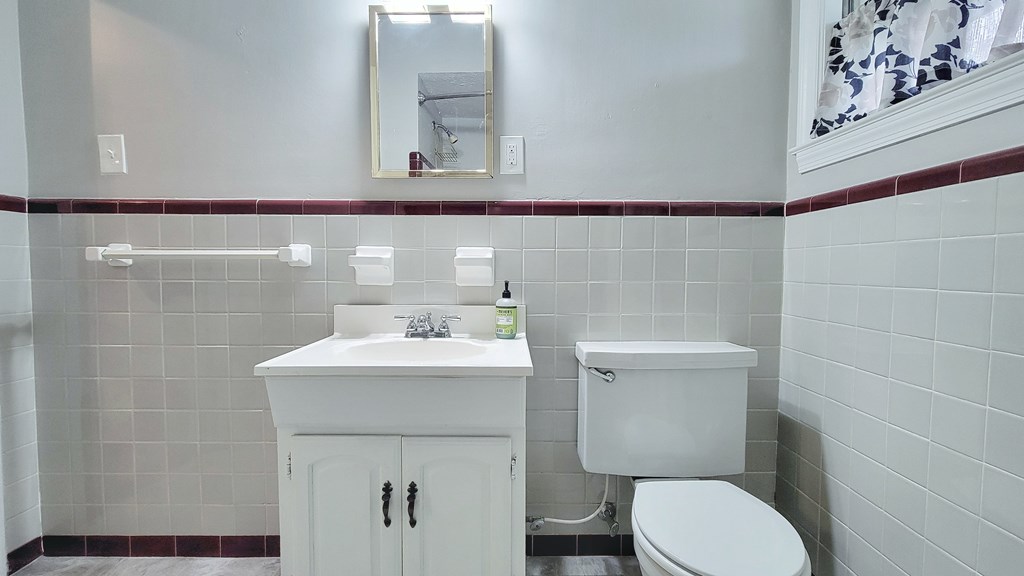 5552 Perry Avenue Columbus, GA 31909 - Photo 12 of 14 a bathroom with a toilet sink and mirror