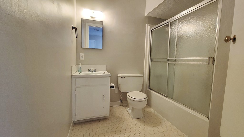 5552 Perry Avenue Columbus, GA 31909 - Photo 13 of 14 a bathroom with a sink a toilet and shower