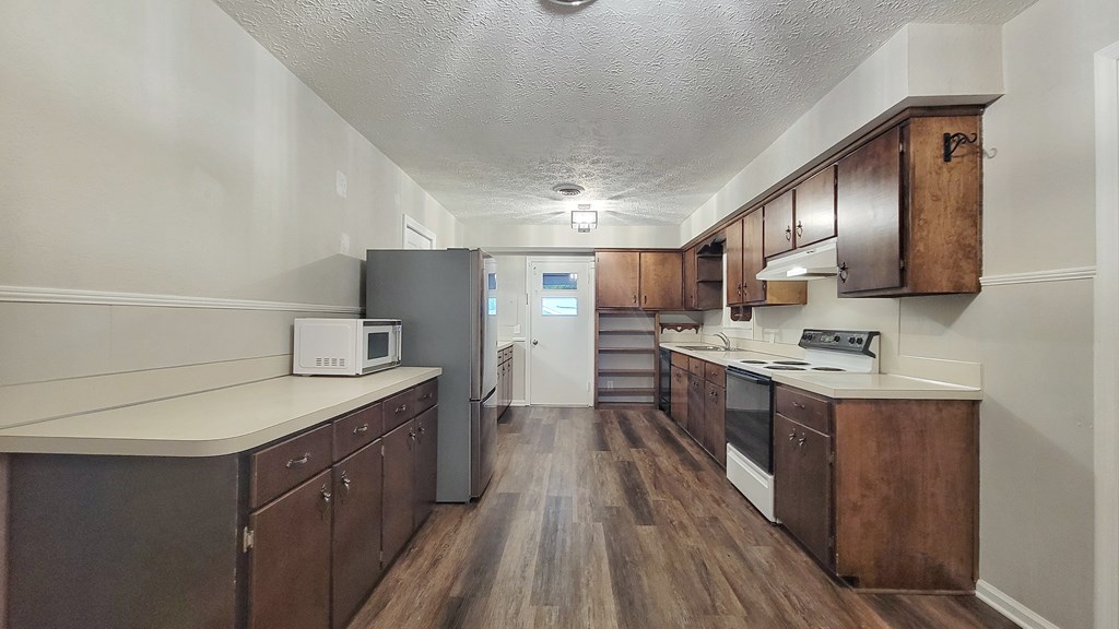 5552 Perry Avenue Columbus, GA 31909 - Photo 2 of 14 a kitchen with a sink refrigerator and cabinets