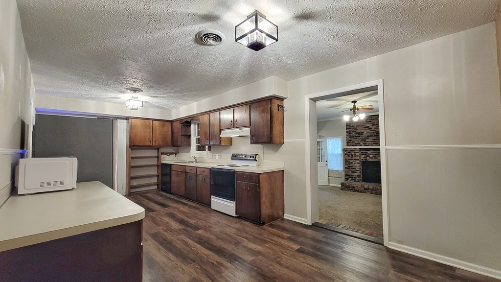 5552 Perry Avenue Columbus, GA 31909 - Photo 3 of 14 a kitchen with stainless steel appliances a sink stove and refrigerator