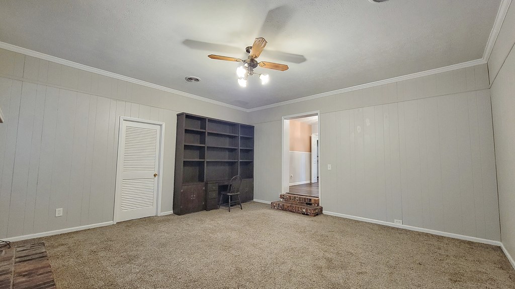 5552 Perry Avenue Columbus, GA 31909 - Photo 6 of 14 an empty room with a ceiling fan and window