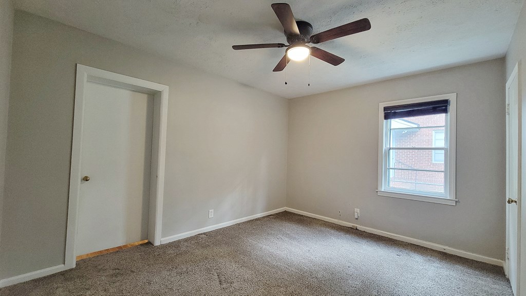 5552 Perry Avenue Columbus, GA 31909 - Photo 8 of 14 an empty room with a window and a fan